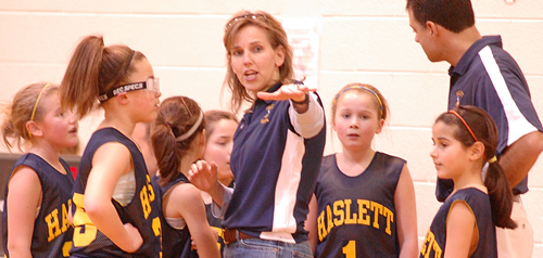 Woman coaching girls basketball