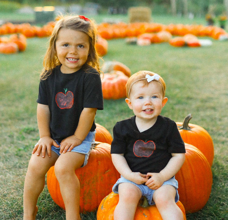 Children sitting on a pumpkin