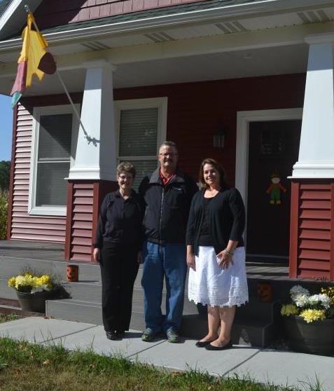 The Olsen family with GreenStone financial services officer, Emelee Rajzer, on the steps of their newly built dream home. 