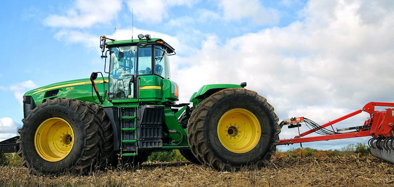 John Deere tractor in field with Blue Sky