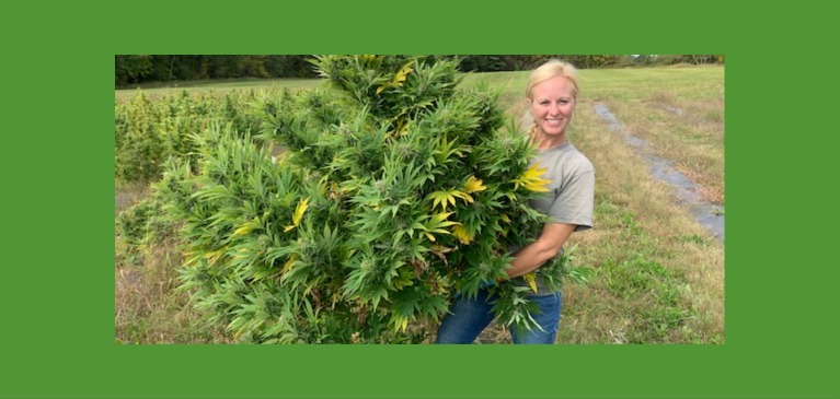 Photo of Jennifer Eis with hemp plant