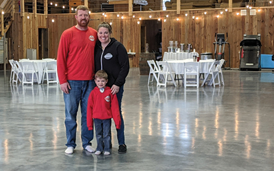 Chris and Dea with son in barn. 