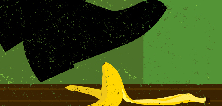 Illustration of a man’s large black shoe inches away from stepping on a slippery banana peel on a wood brown floor with a green wall in background. 