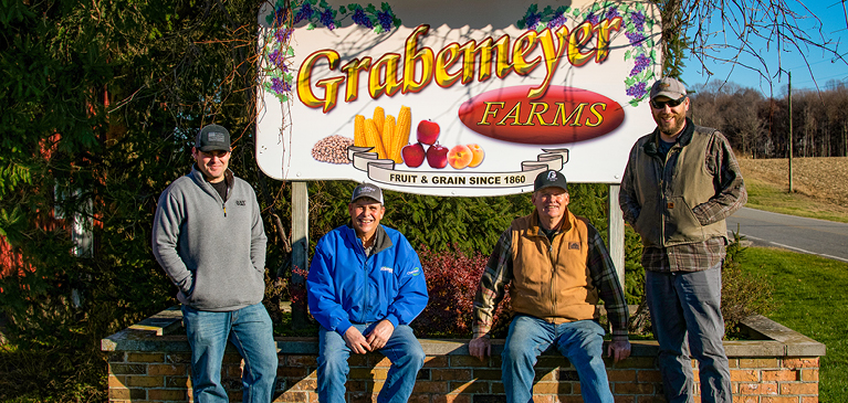 Grabemeyer Farms sign with family in front