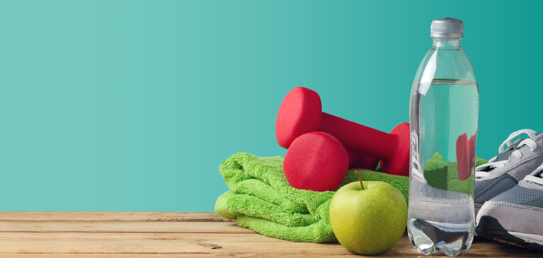 Water bottle with fitness equipment on blue background