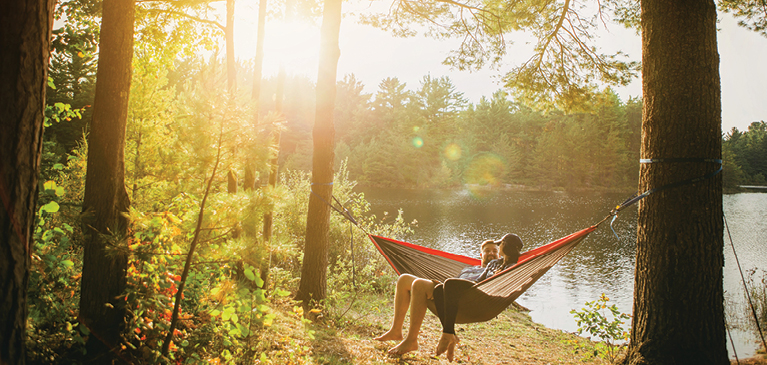 Couple in hammock in an outdoor setting