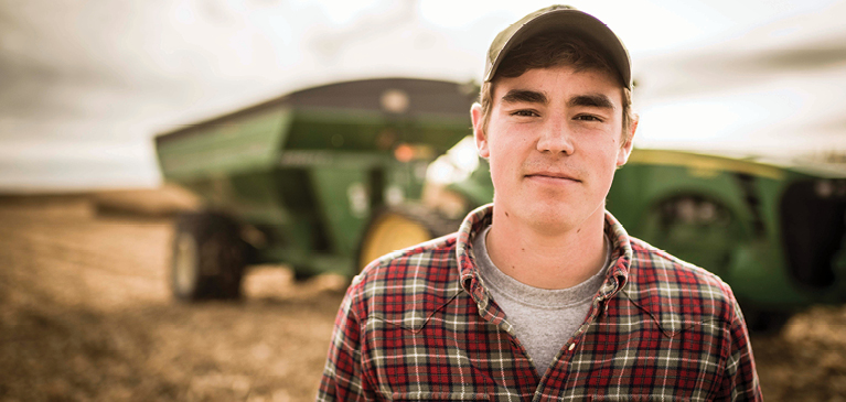 Farmer standing in front of a tractor 