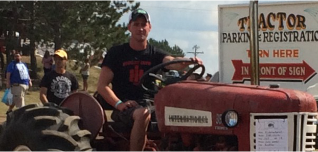 Guy driving a tractor in a parade