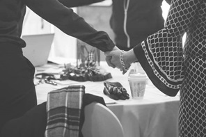 Women holding hands during FWS.
