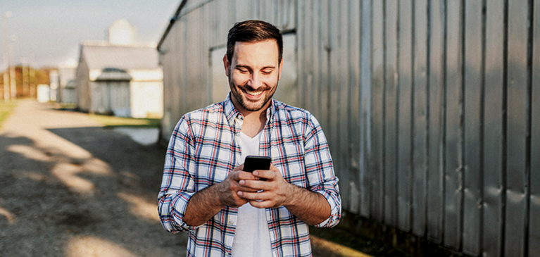 Male farmer checking his phone