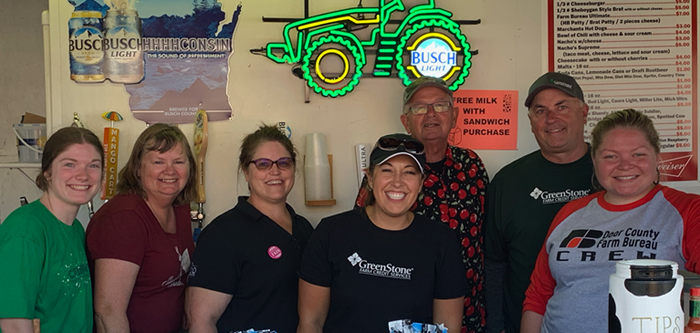 Group of people standing in kitchen
