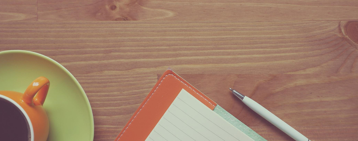 Coffee and notebook on a table