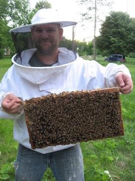 Adam Ingrao with a hive of honeybees