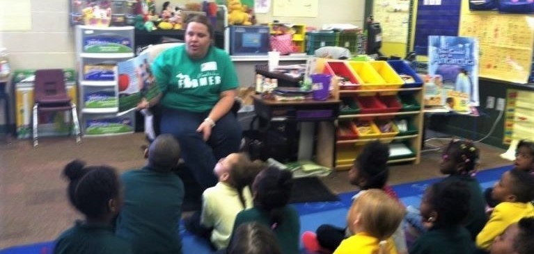 GreenStone employee, Amanda Kutchey, reading to young students during Ag in the classroom event.