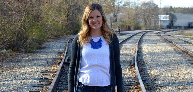 Becca Middaugh standing on train tracks