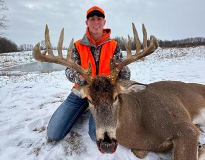 Deer Challenge Winner Sam Marquardt posing with his 19-point buck. 