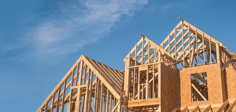 Peaks of House Being Built Blue Sky