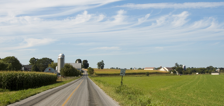 013018-economic-year-in-review-and-look-ahead country road with farm in the background