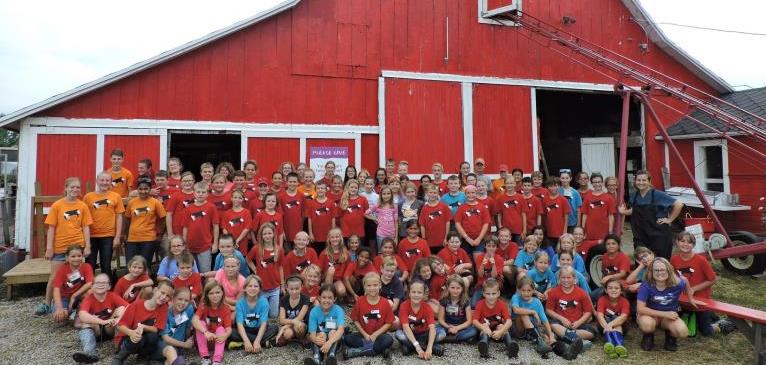 Critter Barn volunteers standing in front of animal barn
