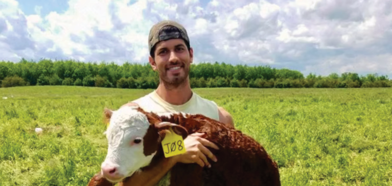 Gregory holding a calf