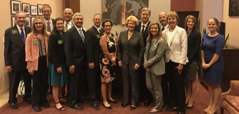 Team GreenStone standing with Senator Debbie Stabenow as she receives her Friend of Farm Credit award
