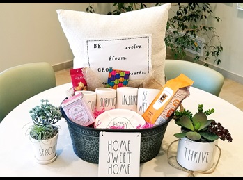 DUNN with cancer basket for fundraiser with pillow, cacti, succulent plants, coffee mugs and gifts from Biggby coffee