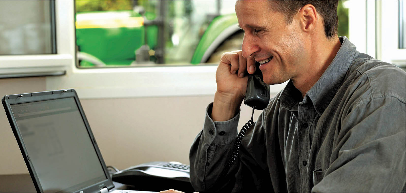 Farmer in office setting talking on the phone