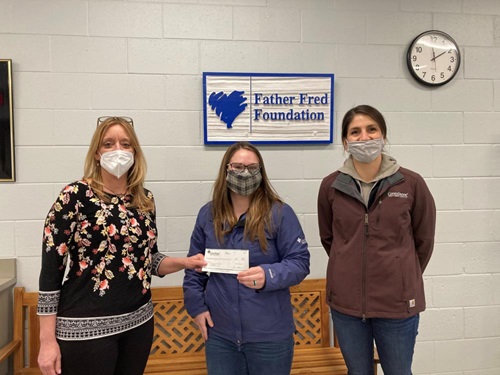 Emily Dreves and Autumn Rector handing off the Member Grown Outreach check to Candice Hamel. 
