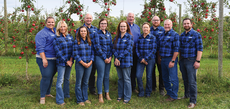 GreenStone's fruit and specialty crop insurance team in apple orchard during peak season.
