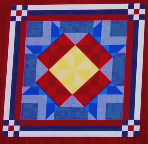 McCune family farm's barn quilt clock with red, blue, yellow and white