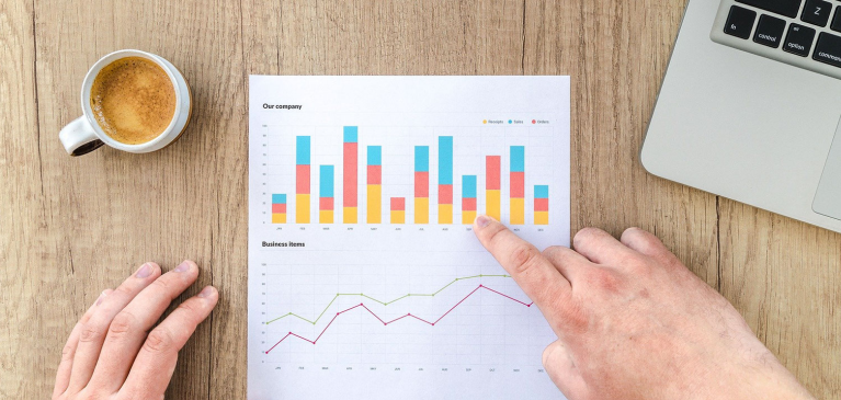 Data sheet with hand pointing to it.