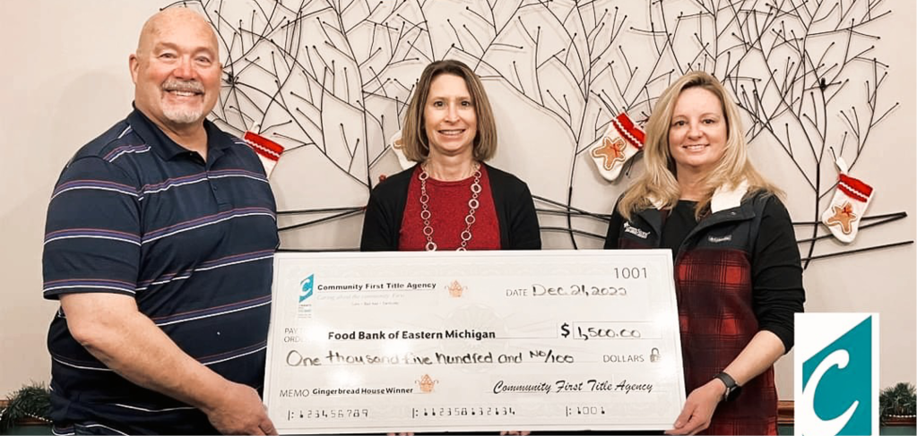 Tara Ozbat pictured with large check