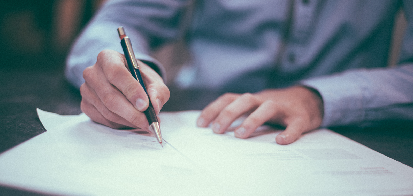 Person writing on a piece of paper