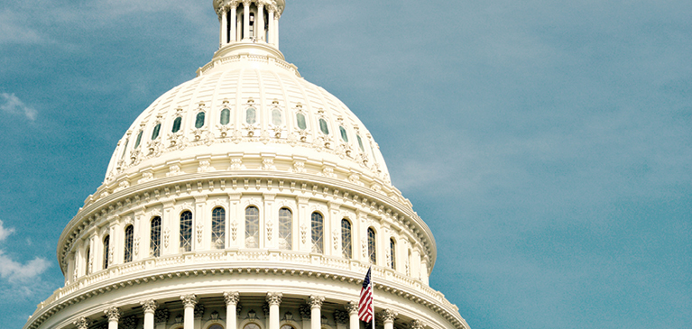 Picture of top of Capitol building in Washington D. C., with blue sky background