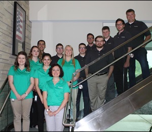 Summer interns posing on the stairs of the corporate office