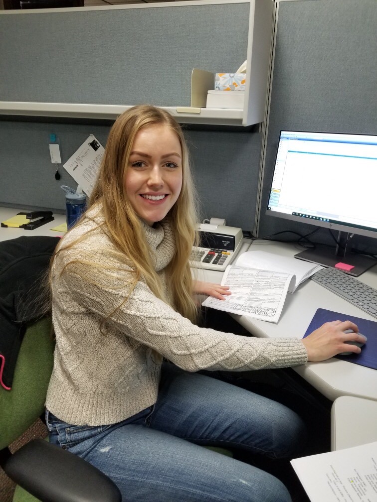 Michaela Wiesman sitting at desk. 
