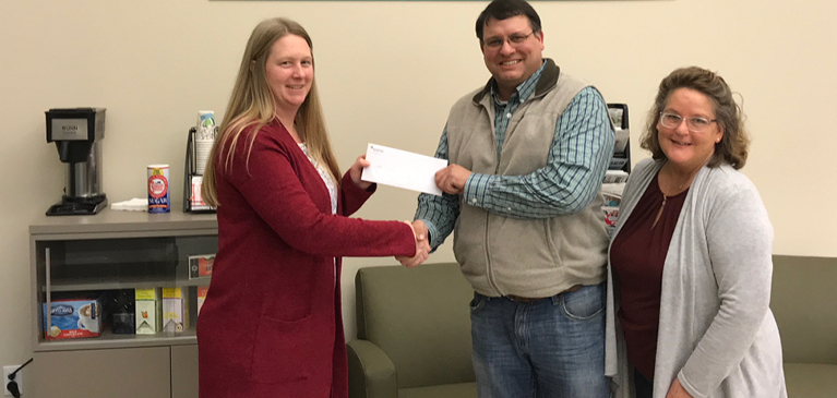 VP of lending, Jennifer Whitford, at Alma branch presenting check to Gratiot County Fair Campaign Come Grow with us