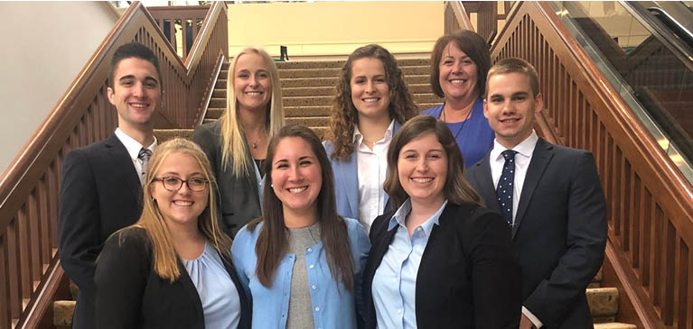 MSU NAMA students posing for a photo on a staircase in Kansas City, Missouri at the NAMA national conference.