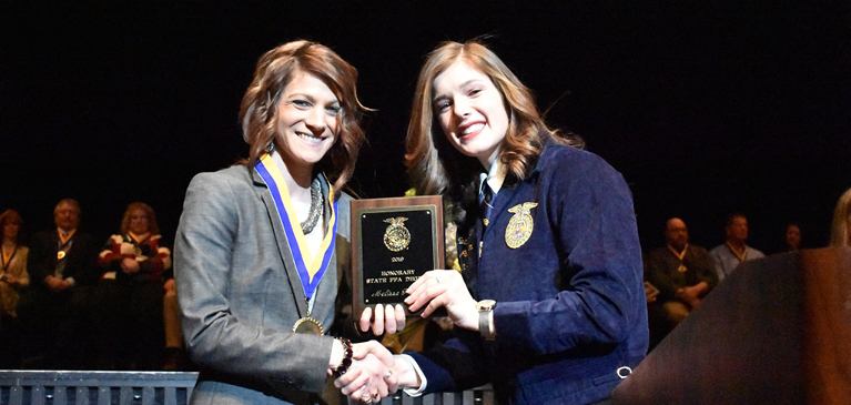 Melissa Rogers shaking hands with Caitlin Henne