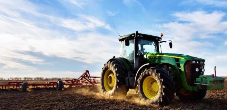Tractor plowing field