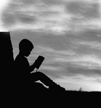 Silhouette of a child reading