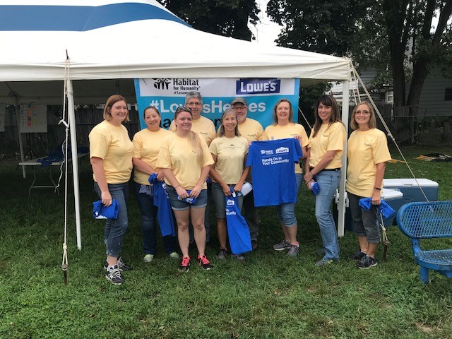 Greenstone staff in front of a pop-up tent at Rock the block