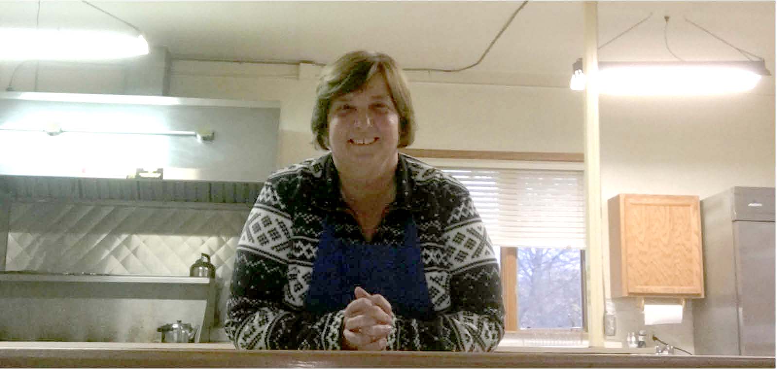 Woman leaning on a food counter