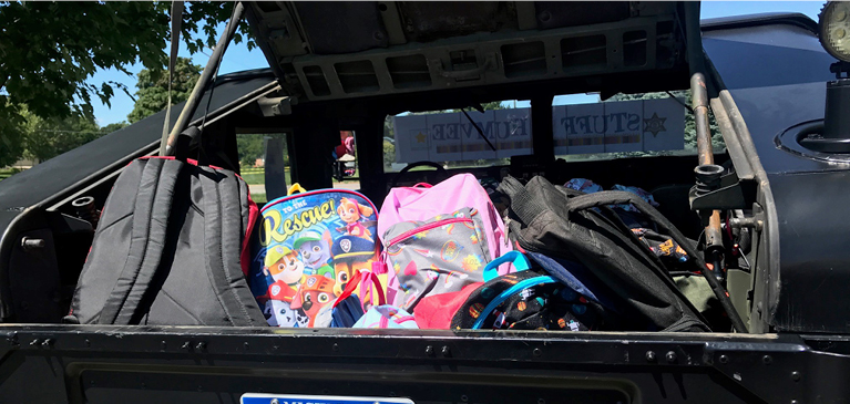 A Humvee stuffed with back to school supplies