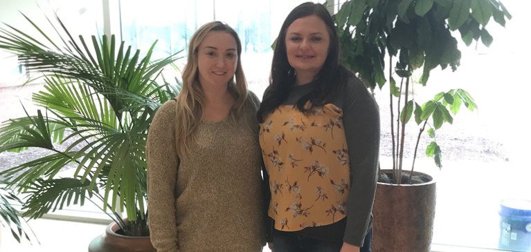two young female interns in office