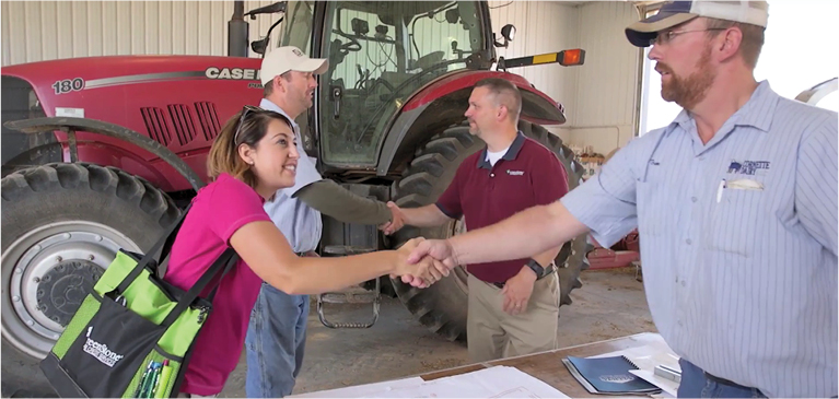 Greenstone employees interacting with customers in a farm shop.