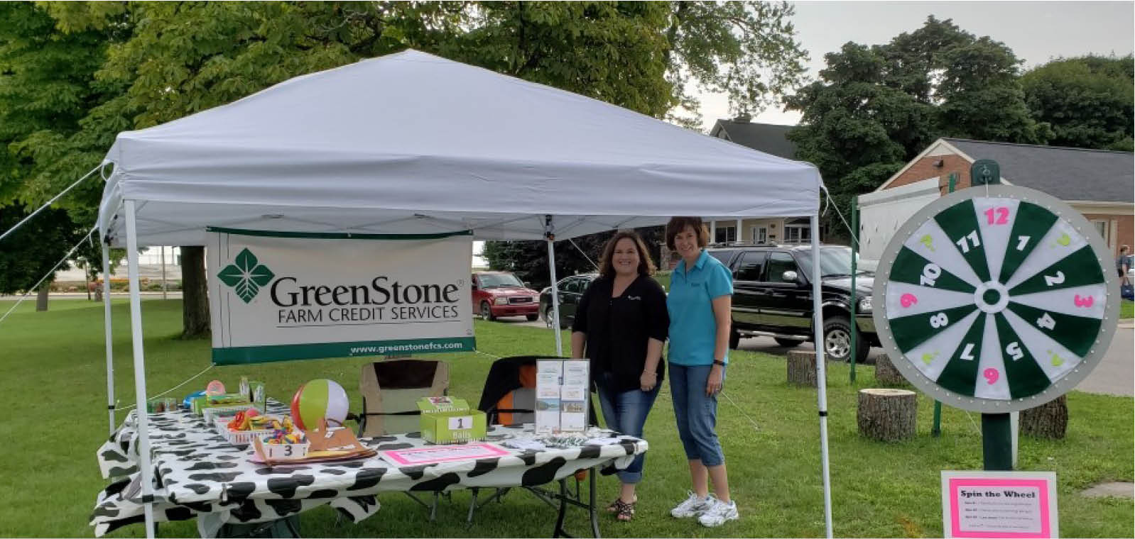 Two women outside GreenStone tent at AgVenture Day