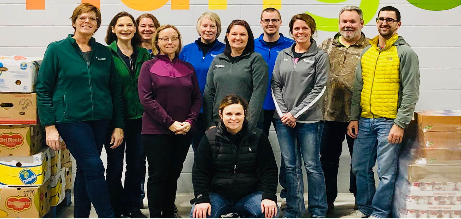 People gathering in front of wall