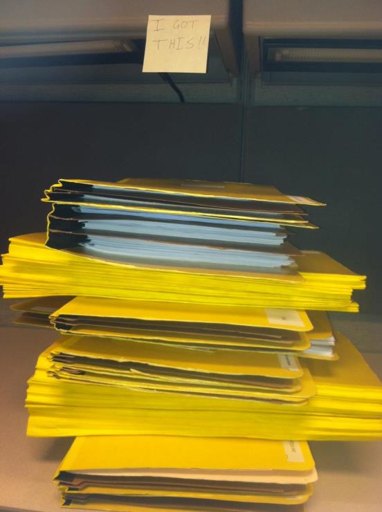 A stack of files full of Henry's summer projects