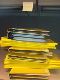 A stack of files full of Henry's summer projects